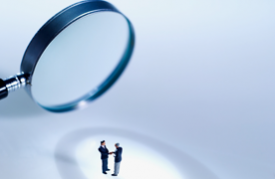 Photo of magnifying glass over two people